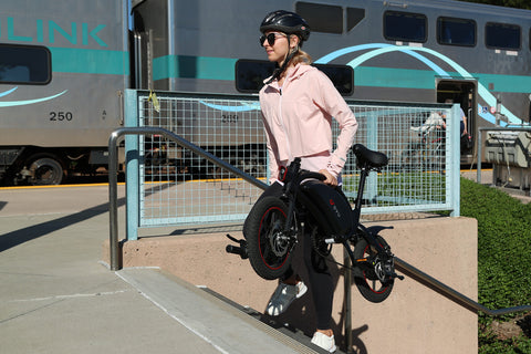Femme transportant vélo électrique DYU A5, style urbain et pratique. Femme transportant vélo électrique DYU A5, style urbain et pratique.